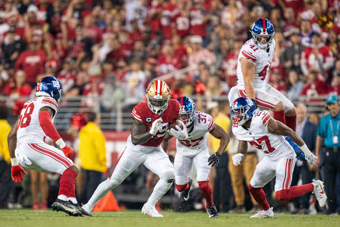 September 21, 2023; Santa Clara, California, USA; San Francisco 49ers wide receiver Deebo Samuel (19) runs the football against New York Giants linebacker Bobby Okereke (58), cornerback Tre Hawkins III (37), linebacker Micah McFadden (41), and safety Jason Pinnock (27) during the third quarter at Levi's Stadium. Mandatory Credit: Kyle Terada-USA TODAY Sports